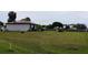 Expansive backyard featuring a freshly mowed lawn and a classic white fountain at 313 Oak Track Trce, Ocala, FL 34472