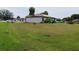 Large backyard showcasing a well-maintained lawn extending from the side of the house at 313 Oak Track Trce, Ocala, FL 34472