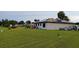 Large green backyard featuring home exterior, solar panels and landscaping at 313 Oak Track Trce, Ocala, FL 34472