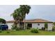 Charming single-story home featuring a well-manicured lawn and mature palm trees at 313 Oak Track Trce, Ocala, FL 34472