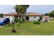 Charming single-story home featuring a well-manicured lawn and mature palm trees at 313 Oak Track Trce, Ocala, FL 34472