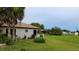 Side yard featuring a neatly kept lawn, lush plants, and neighborhood views at 313 Oak Track Trce, Ocala, FL 34472
