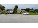 Residential street showcasing a single-story home with a well-kept front yard and ample parking at 313 Oak Track Trce, Ocala, FL 34472