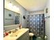 Bathroom with vanity, mirror, and shower/tub with a patterned curtain at 3525 E Fort King St # 140, Ocala, FL 34470
