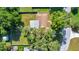 An aerial view shows a yard with a lush green lawn, storage shed, and backyard fire pit, perfect for relaxation at 3831 Se 48Th St, Ocala, FL 34480