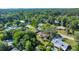 Aerial view of a residential area featuring homes with pools and lush trees, creating a private and tranquil oasis at 3831 Se 48Th St, Ocala, FL 34480