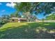 An expansive backyard with yellow house and spacious lawn, perfect for outdoor activities and enjoying the natural surroundings at 3831 Se 48Th St, Ocala, FL 34480
