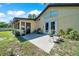The backyard features a small patio and lush landscaping surrounding the property with the home's exterior painted a subtle yellow at 3831 Se 48Th St, Ocala, FL 34480