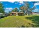 Expansive backyard featuring a home with yellow siding, a screened-in porch and plenty of room to entertain friends at 3831 Se 48Th St, Ocala, FL 34480