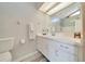 Bright bathroom featuring a white vanity, framed mirror, and a well-lit shower at 3831 Se 48Th St, Ocala, FL 34480