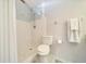 Bright bathroom featuring a shower with white tile surround and white fixtures at 3831 Se 48Th St, Ocala, FL 34480