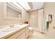 Bathroom featuring a vanity, soaking tub with shower and tile flooring at 3831 Se 48Th St, Ocala, FL 34480