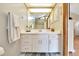 Bathroom featuring vanity with white cabinets, large mirror and tile flooring at 3831 Se 48Th St, Ocala, FL 34480