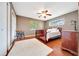 Cozy bedroom featuring hardwood floors, ceiling fan and bright natural light at 3831 Se 48Th St, Ocala, FL 34480