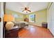 Bedroom with wood floors, ceiling fan and a window with lots of natural light at 3831 Se 48Th St, Ocala, FL 34480