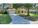 Charming home with a spacious lawn and a long driveway, showcasing great curb appeal in a desirable neighborhood at 3831 Se 48Th St, Ocala, FL 34480