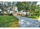 A well-maintained front lawn and mature trees surround a home with a garage, adding to its curb appeal at 3831 Se 48Th St, Ocala, FL 34480