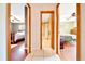 Hallway that leads to bedrooms with ceiling fans and a bathroom with tile flooring at 3831 Se 48Th St, Ocala, FL 34480
