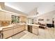 Bright kitchen featuring white cabinetry, view into the dining area, and stainless steel appliances at 3831 Se 48Th St, Ocala, FL 34480