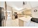 Bright kitchen featuring white cabinets, modern appliances, and a breakfast bar in a well-lit space at 3831 Se 48Th St, Ocala, FL 34480
