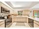 Bright kitchen showcasing white cabinetry, stainless steel appliances, and ample counter space at 3831 Se 48Th St, Ocala, FL 34480