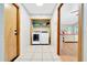 Tile laundry room with washer and dryer; view into bedroom at 3831 Se 48Th St, Ocala, FL 34480
