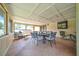 Enclosed porch featuring a ceiling grid, neutral colored walls, and comfortable furniture perfect for relaxing or entertaining at 3831 Se 48Th St, Ocala, FL 34480