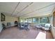 Relaxing sunroom with lots of natural light and a view of the fenced in backyard at 3831 Se 48Th St, Ocala, FL 34480