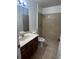 Bathroom featuring a vanity with sink, toilet, and a tile walk-in shower at 3858 Sw 161St St, Ocala, FL 34473