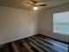 Cozy bedroom with modern floors, a ceiling fan, and a window letting in natural light at 3858 Sw 161St St, Ocala, FL 34473
