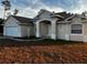 Charming single-story home with stucco exterior, manicured lawn, and attached two-car garage at 3858 Sw 161St St, Ocala, FL 34473