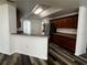 Modern kitchen boasts wood cabinets, wood flooring, and a bar-height countertop, perfect for entertaining at 3858 Sw 161St St, Ocala, FL 34473