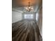 Spacious living room featuring hardwood floors and stylish lighting fixtures at 3858 Sw 161St St, Ocala, FL 34473