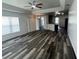 Spacious living room with wood flooring, ceiling fan, recessed lighting and sliding glass door at 3858 Sw 161St St, Ocala, FL 34473
