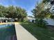 Serene backyard featuring a sparkling pool, lush greenery, and a privacy fence for ultimate relaxation at 3950 Sw 54Th Ct, Ocala, FL 34474