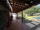 Relaxing outdoor pool deck with comfortable hammocks and a tranquil view of the backyard and pool at 3950 Sw 54Th Ct, Ocala, FL 34474