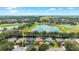 Aerial view of houses with a lake and trees in the background at 4094 Sw 51St Ct, Ocala, FL 34474
