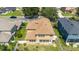 Aerial view of a home's backyard, highlighting its brown shingle roof, white fencing, and well-maintained lawn at 4094 Sw 51St Ct, Ocala, FL 34474