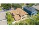 Aerial view of a home's backyard, highlighting its brown shingle roof, white fencing, and well-maintained lawn at 4094 Sw 51St Ct, Ocala, FL 34474