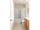 Bright bathroom featuring a shower-tub combo, tile flooring, and wood vanity at 4094 Sw 51St Ct, Ocala, FL 34474