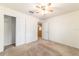 Bedroom with carpet, ceiling fan, closet, and doorway to another room at 4094 Sw 51St Ct, Ocala, FL 34474