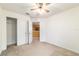 Bedroom with carpet, ceiling fan, closet, and doorway to the kitchen at 4094 Sw 51St Ct, Ocala, FL 34474