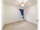 Cozy bedroom features neutral carpet, a ceiling fan, and a window with blinds at 4094 Sw 51St Ct, Ocala, FL 34474