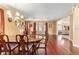 Elegant dining room showcasing hardwood floors, stylish chandelier, and a seamless transition to the living area at 4094 Sw 51St Ct, Ocala, FL 34474
