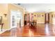 Open dining room featuring beautiful hardwood floors and natural light from large windows with decorative curtains at 4094 Sw 51St Ct, Ocala, FL 34474