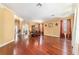 Open-concept dining area featuring gleaming hardwood floors, decorative curtains, and abundant natural light at 4094 Sw 51St Ct, Ocala, FL 34474