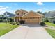 Inviting two-story home featuring manicured lawn, tidy shrubbery, and neutral stucco exterior with an attached two car garage at 4094 Sw 51St Ct, Ocala, FL 34474