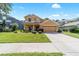 Charming two-story home featuring a landscaped yard and a two-car garage at 4094 Sw 51St Ct, Ocala, FL 34474