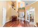 Bright foyer featuring high ceilings, wooden floors, and a staircase with decorative plants at 4094 Sw 51St Ct, Ocala, FL 34474