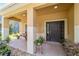 Charming front porch with tiled flooring and well-maintained plants at 4094 Sw 51St Ct, Ocala, FL 34474